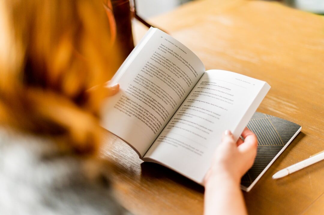 person reading self help book