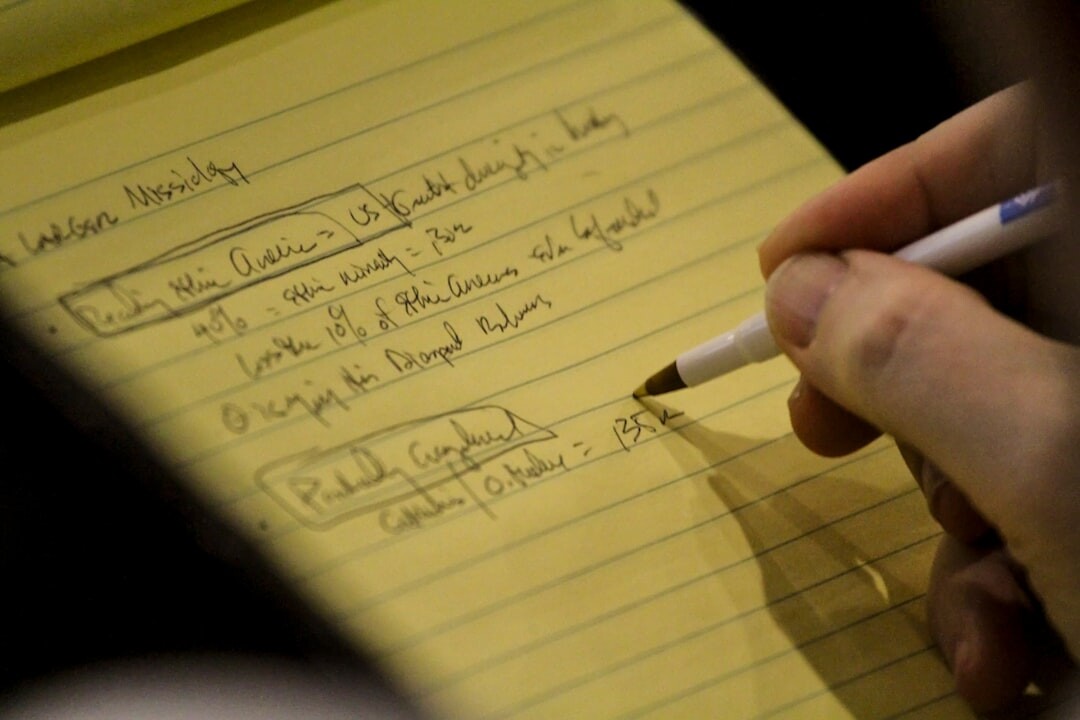person tracking goals on notebook